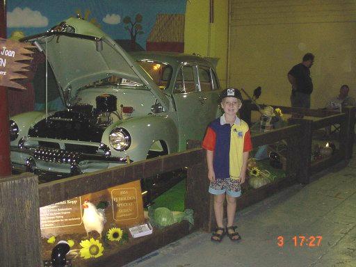 Leo standing in front of early Holden