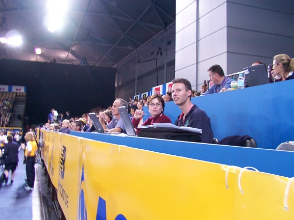 Ainsley sitting in the press area at the Gymnastics