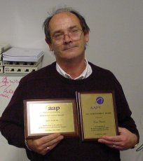 Ken holding his awards