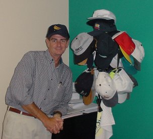 Clark next to a selection of hats